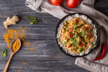 Top down view of a delicious chicken tikka masala with Indian spices and Basmati rice