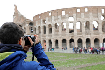 while photographer takes a picture of the famous Roman amphithea