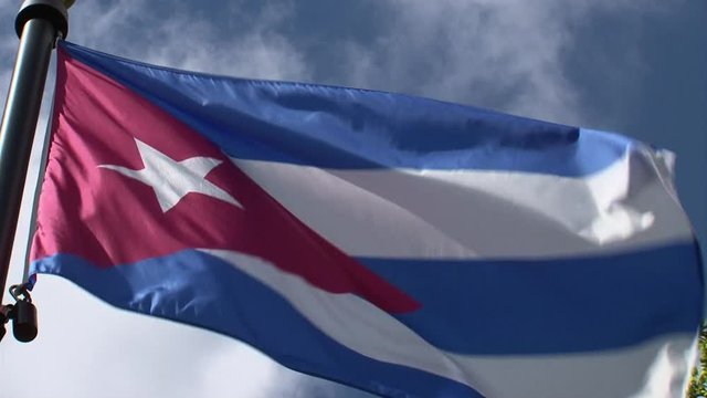 Cuba flag waving in breeze-close up-sunny day-blue sky-Miami-Calle Ocho-SW 8th Street-Cuban-American