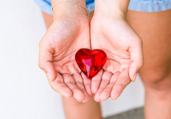 woman hands holds red heart