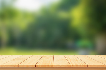 Wood floor with blurred trees of nature park background and summer season, product display montage