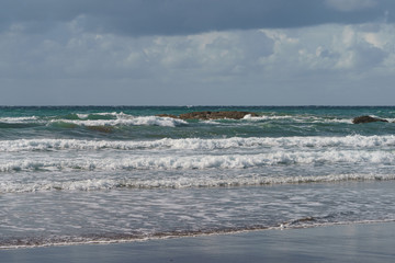 Sun beams over the Atlantic ocean after the rain.