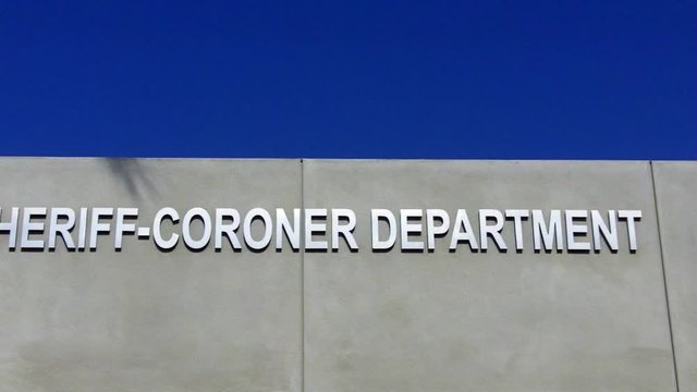 Generic Sheriff Coroner Department Sign On Bldg Slow Zoom