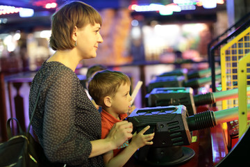 Mother and son playing in amusement center