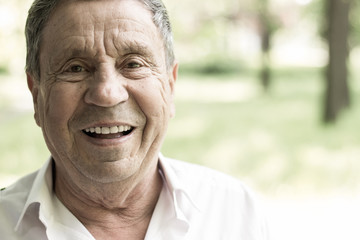 Portrait of a smiling senior man in Nature