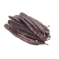 big heap of carob pods isoalted on white background