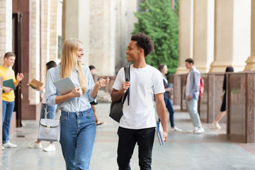 Multiracial students walking in university campus during break