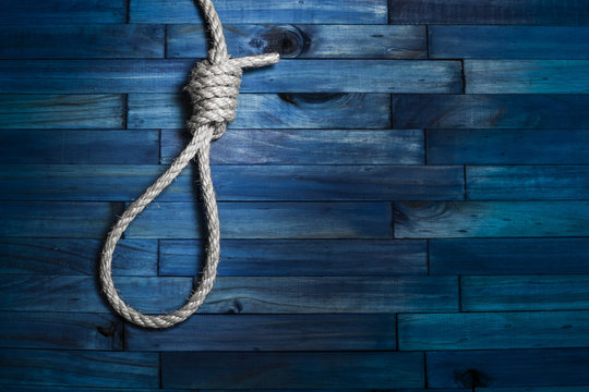 Suicide rope on blue wooden background