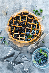 Traditional homemade american blueberry pie with lattice pastry, top view.