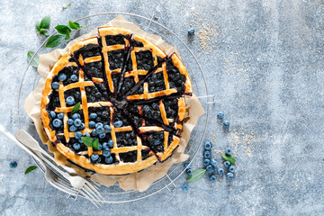 Traditional homemade american blueberry pie with lattice pastry, top view.