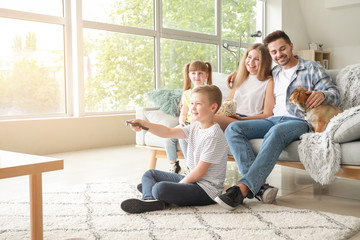 Happy family watching TV at home