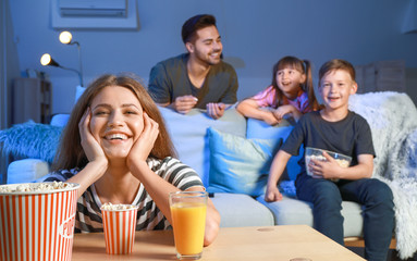 Happy family watching TV in evening