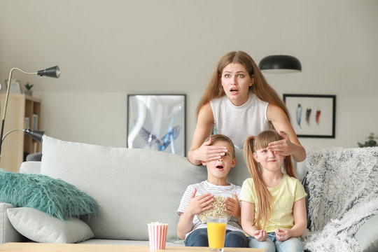 Family Watching Scary Movie At Home