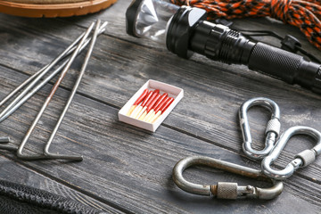 Set of items for camping on wooden background