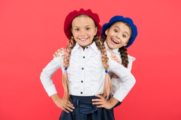 Fashion trends every girls needs for back to school. Happy school kids with fashion look on pink background. Small girls with long hair plaits smiling in fashion berets. Fashion for little students