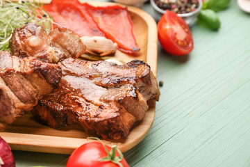 Plate with tasty grilled meat on table