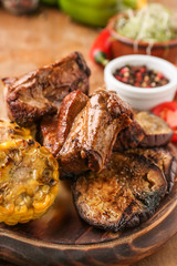 Tasty grilled meat with vegetables on board, closeup