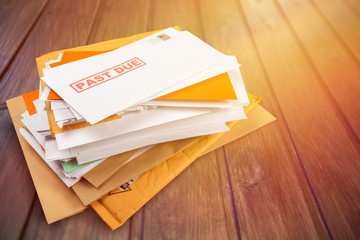 Pile of envelopes with overdue utility bills isolated on white