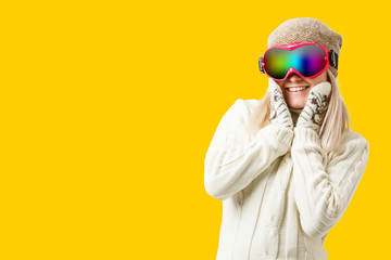 Woman Skier Standing at Snow Looking . Winter yellow, orange, background