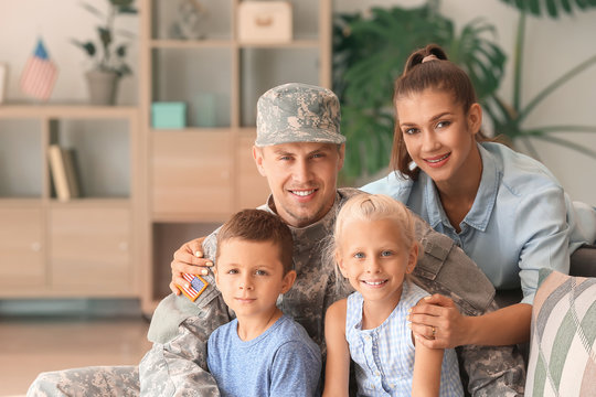 Happy military man with his family at home