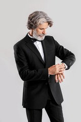 Obraz na płótnie Canvas Fashionable senior man in stylish suit on light background