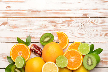Different citrus fruits on wooden background