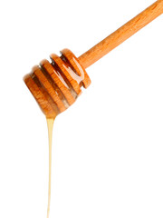 Wooden honey dipper on white background