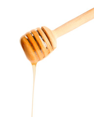 Wooden honey dipper on white background