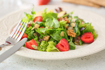 Plate with fresh tasty salad on table, closeup