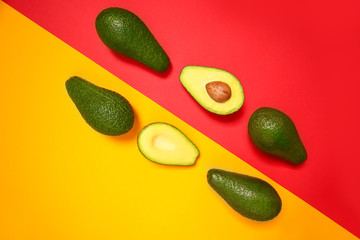 Tasty ripe avocados on color background
