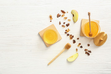Composition with sweet honey on white wooden background