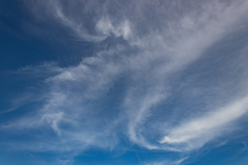 Blue sky background with tiny clouds