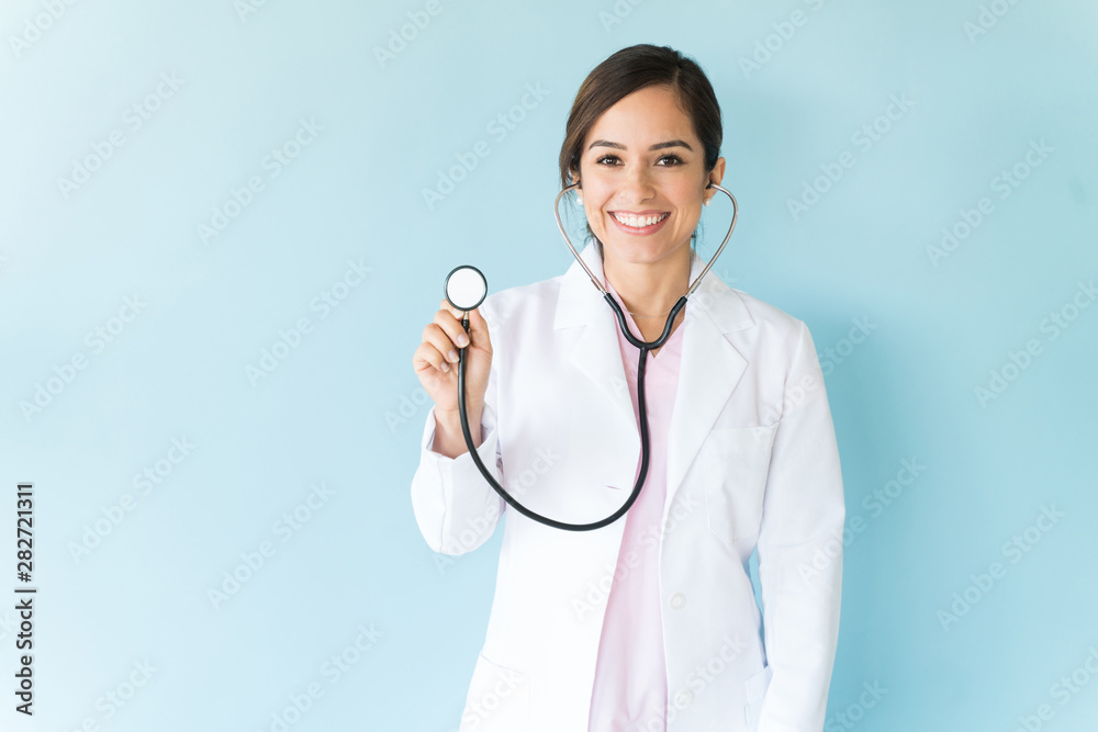 Wall mural Female Doctor With Stethoscope On Isolated Background