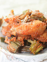 Breaded crispy fried chicken drumstick in the basket.