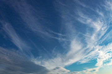 Blue sky background with tiny clouds