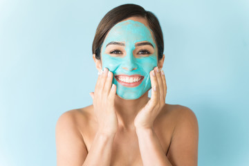 Female Applying Cosmetics Against Blue Background