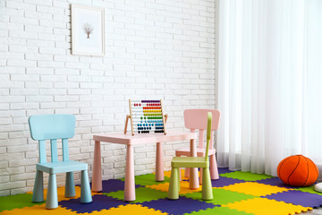 Stylish playroom interior with toys and modern furniture. Space for design