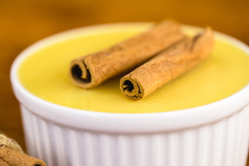 Typical Brazilian dessert, sweet of mingua, called in Brazil of curau. Typical sweet of June party. Brazilian sweet corn, corn mousse on a wooden background with copy space.