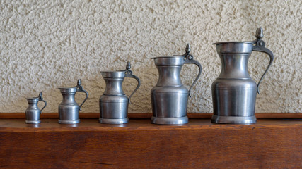 Set of five antique pewter jugs of different sizes