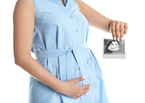 Pregnant woman with ultrasound picture on white background, closeup