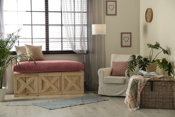 Elegant living room interior with comfortable armchair near window