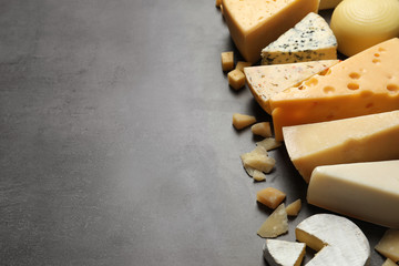Fototapeta premium Different delicious cheeses on grey table, space for text