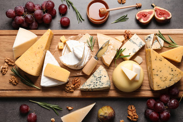Fototapeta Flat lay composition with different types of delicious cheese on table obraz