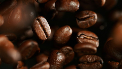 Coffee beans flying in the air, macro photo
