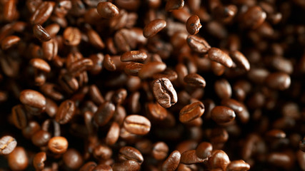 Coffee beans flying in the air, macro photo