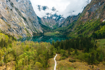 Scenic mountain panorama with green meadows and idyllic turquoise Lake Oberer