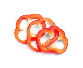 Slices of ripe red bell pepper on white background
