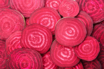 Sliced red beets as background, top view