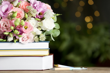 Composition with flowers and books on wooden table, space for text. Teacher's day