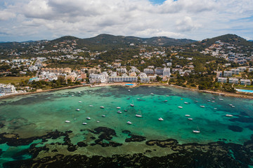 Aerial view of city and bay with yachts.